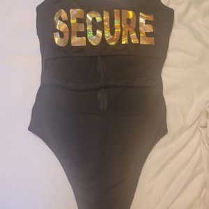 One piece bathing suit with cut out middle. Be Secure